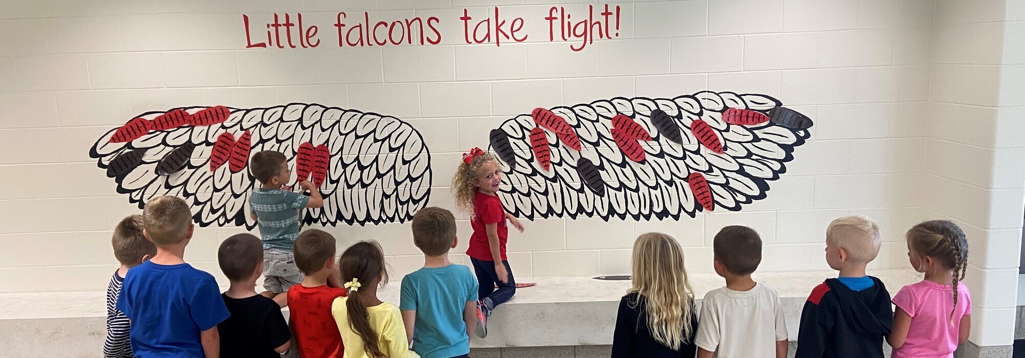 Children adding wings to the wall