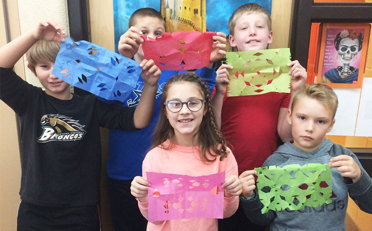Displaying their cut paper creations