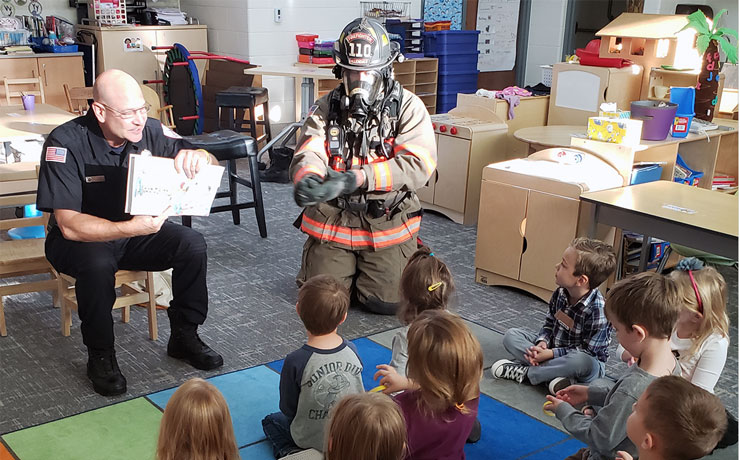 Firefighters telling a story to ECC students